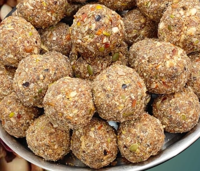 Gond and dry-fruit laddoos heaped in a steel bowl